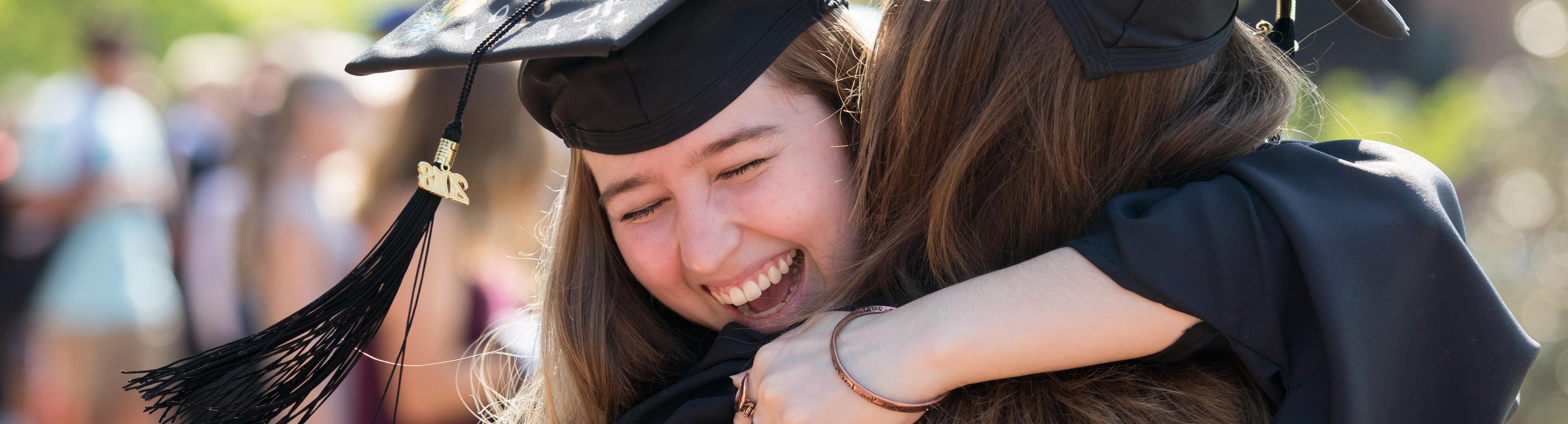 Students hugging at graduation.